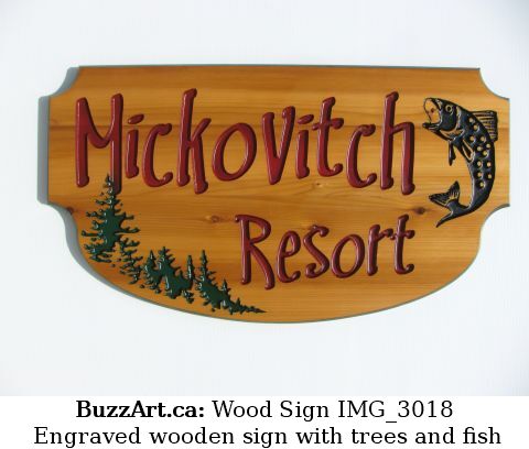 Engraved wooden sign with trees and fish